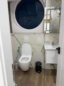 a small bathroom with a toilet and a sink at EDEAN Apartments 4 in Tirana