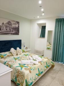 a bedroom with a large bed with towels on it at Al Punto Giusto in Catania