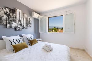 a bedroom with a large white bed with a window at Olympe de Provence in Caromb +176 photos