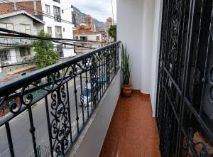 a balcony with black railings and a view of a city at Morada Living Bello HomeStay in Bello
