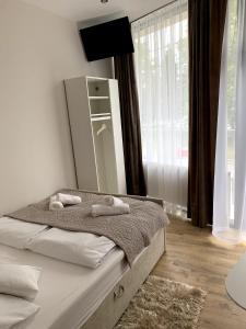 a bedroom with a bed with two towels on it at Na Rogu in Sandomierz +47 photos