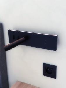 a black wall mounted speaker on a wall at Zaza Suites in Middelkerke