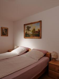 a bedroom with two beds and a painting on the wall at Gschwingerhof in Riedering