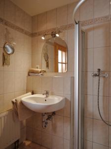 a bathroom with a sink and a shower at Gschwingerhof in Riedering +20 photos