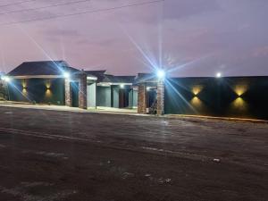 a house with lights on the side of a street at Qten Camp in Pietermaritzburg