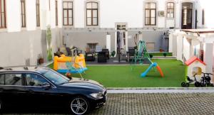 a car parked in front of a backyard with a playground at Residencial Moderna in Figueira da Foz