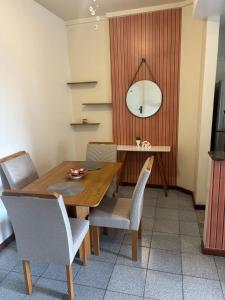 a dining room with a wooden table and chairs at Apartamento, Campos dos Goytacazes, centro in Campos dos Goytacazes +8 photos