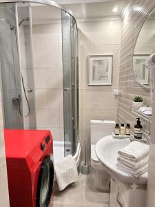 a bathroom with a shower and a toilet and a sink at Stefan 64 in Chişinău