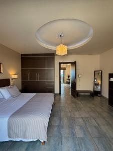 a bedroom with a large bed and a large ceiling at Gonis Suites in Palaiochora