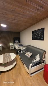a living room with two beds and a couch at Karlskrona in Rödeby