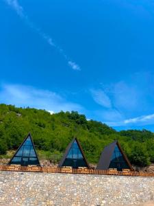 a group of three glass buildings on top of a hill at Bujtina Panorama Kir in Kashec