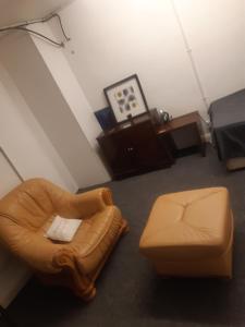 a living room with a chair and a ottoman at Vincente's in Chatham