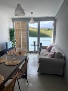 a living room with a couch and a table at Apartamentos en playa Canido in Malpica