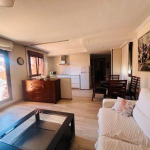 a living room with a couch and a table at Casa Yayi in Luanco
