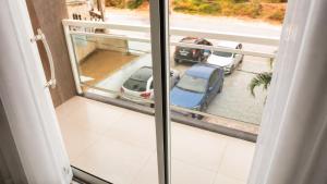 a balcony with a view of a parking lot at Nura Pousada in Maragogi
