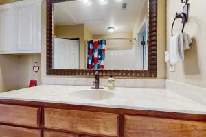 a bathroom with a sink and a mirror at Waterfront Home with Kayak, View, Fire Pit & WiFi - Dog-Friendly in Buchanan Dam +14 photos