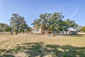 an open field with a house in the background at Waterfront Home with Kayak, View, Fire Pit & WiFi - Dog-Friendly in Buchanan Dam