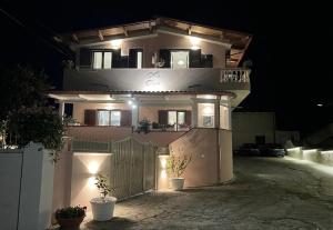 a house with lights on the side of it at night at Villa Rosa in Tropea