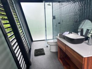 a bathroom with a sink and a toilet at AsiaTica Lodge Volcano and Lake View in El Castillo de La Fortuna