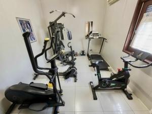 a gym with two treadms and two exercise bikes at Amapolas - Villaggio & Camping in Mombaroccio