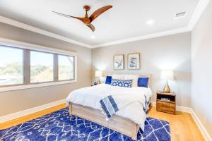 a bedroom with a bed and a ceiling fan at Bright & Spacious Family Home with Firepit, Lake Views, Furnished Deck, Free WiFi in Lago Vista +31 photos
