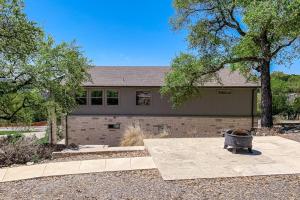 a home with a yard with a fire pit at Bright & Spacious Family Home with Firepit, Lake Views, Furnished Deck, Free WiFi in Lago Vista