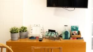 a wooden shelf with plants and other items on it at Casinha Alice in Nazaré