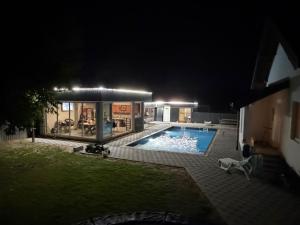 a house with a swimming pool at night at Vikend Kuca Okanovic in Gradačac