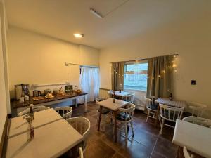 a dining room with tables and chairs and a window at Torre al Sur in Ushuaia