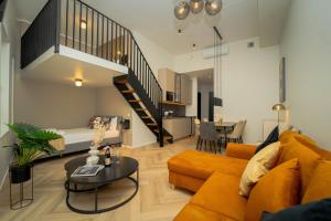 a living room with a couch and a table at Luise LuXe Suites in Tallinn