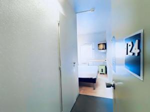 a room with a door and a bedroom with a bed at ibis Budget Beaune in Beaune +52 photos