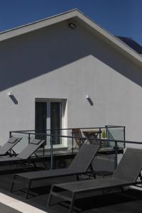 a group of chairs and tables on a balcony at Casa Vale do Douro in Mesão Frio +43 photos