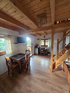 a dining room with a table and chairs and a loft at Hacjenda in Redło