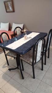 a blue table with two chairs and a table and a table and chairs at Barrio Aeropuerto 1 in RSA