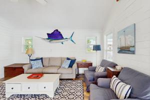a living room with a couch and a table at Lakefront Home on Water with Great Views, Boat Dock, Al Fresco Dining, and WiFi in Kingsland