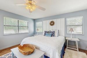 a bedroom with a bed and a ceiling fan at Lakefront Home on Water with Great Views, Boat Dock, Al Fresco Dining, and WiFi in Kingsland