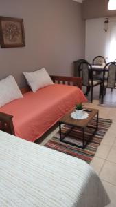 a room with two beds and a coffee table at Barrio Aeropuerto 1 in RSA