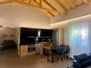 a kitchen with a table and a dining room at S&S Home in Petalidi
