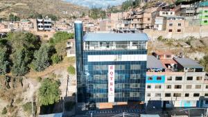 a tall glass building in front of a city at Hotel ROYALS HUARAZ in Huaraz