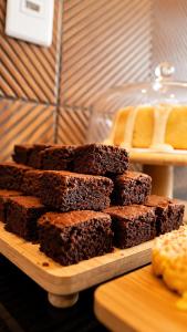 a pile of brownies sitting on a cutting board at Nura Pousada in Maragogi