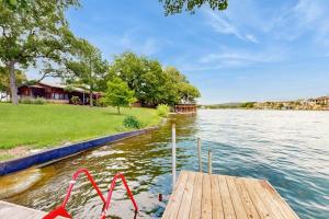 a dock with a boat in the water at Classic Lakefront Cottage with Private Dock, Lovely Lake View, Backyard & WiFi in Kingsland