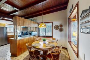 a kitchen with a table and chairs in a room at Classic Lakefront Cottage with Private Dock, Lovely Lake View, Backyard & WiFi in Kingsland