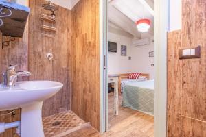 a bathroom with a sink and a walk in shower at Tra Cielo e Mare Rooms Rio Marina in Rio nellʼElba +66 photos