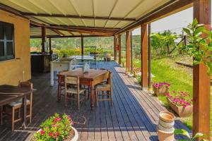an outdoor deck with a table and chairs at Tra Cielo e Mare Rooms Rio Marina in Rio nellʼElba