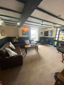 a living room with a couch and a table at The Top House Inn in Lizard