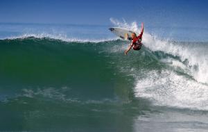 a man riding a wave on a surfboard in the ocean at San Clemente Surf Inn in San Clemente +6 photos