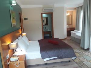 A bed or beds in a room at Island Hotel