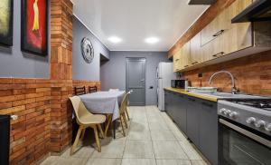 a kitchen with a table and chairs and a sink at 4Season Villa in Tbilisi City