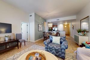 a living room with a couch and a table at Hill Country Corner Condo at The Waters - Central AC, Lake Views & Pool in Horseshoe Bay