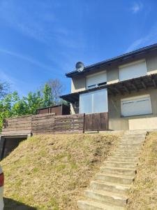 a house on a hill with stairs in front of it at Imprezowy domek in Żeleźnikowa Wielka